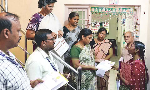 Volunteers from the Chennai Corporation meeting residents with the application form for Ungaludan Stalin camp on Monday
