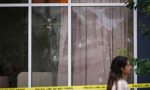 Bullet holes are seen in the windows of a cafe, in Surrey, British Columbia (AP)