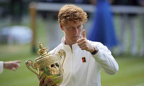 Italy's Jannik Sinner celebrates with the trophy after beating Carlos Alcaraz of Spain to win the men's singles final at the Wimbledon Tennis Championships in London, Sunday, July 13, 2025 (AP)&nbsp;