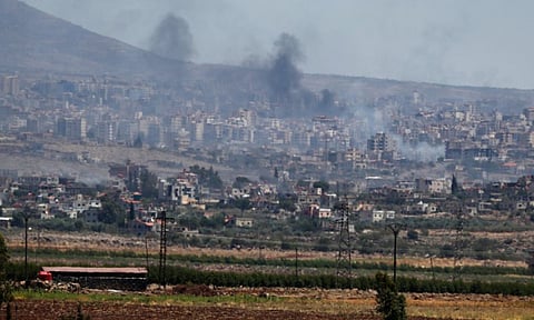 Smoke rise from clashes between Syrian government forces and Druze militias in Sweida city, southern Syria (AP Photo)