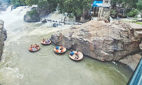 Tourists enjoying coracle rides in Hogenakkal on Monday