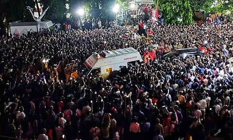 People gather to pay their respects as the mortal remains of former Kerala chief minister and veteran CPI(M) leader V S Achuthanandan being brought in an ambulance.
