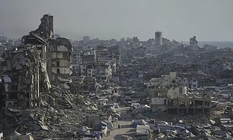 Tents sheltering displaced Palestinians are seen amid war-damaged infrastructure in Gaza City (AP Photo)