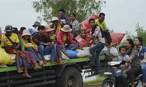 Cambodians sit on a cart of a tractor as they take refuge in Oddar Meanchey province, Cambodia (AP)