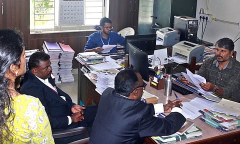 Court staff at the Collector’s office in Coimbatore, on Wednesday