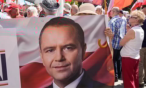 Supporters of Karol Nawrocki, president elect supported by Poland’s right-wing Law and Justice (PiS) party, gather in front of the Supreme Court building in Warsaw, Poland (AP)