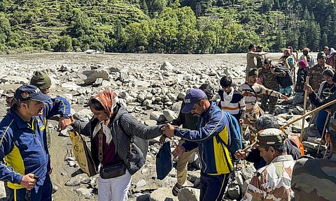 A person uses a satellite-based calling facility set up by the Indian Army to communicate with his family, at cloudburst-hit Uttarkashi (PTI)&nbsp;