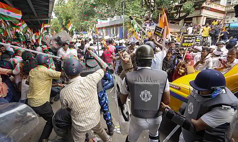 BJP members and security personnel clash during a protest organised to mark the completion of one year of the rape and murder of a trainee doctor at RG Kar hospital, in Kolkata (PTI)