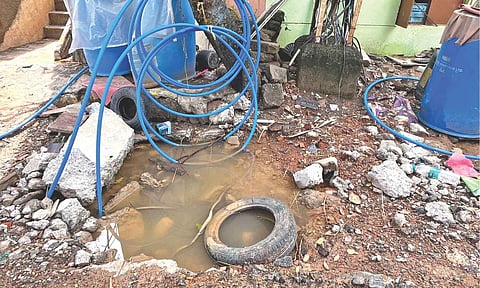 Overhead power cables kept in stagnant water near a junction box at Kannagi Nagar on Sunday