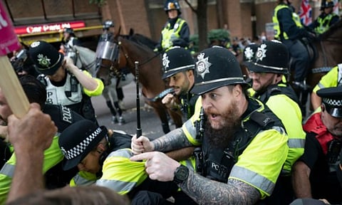 Mounted police officers scuffle with demonstrators during a protest (AP)&nbsp;
