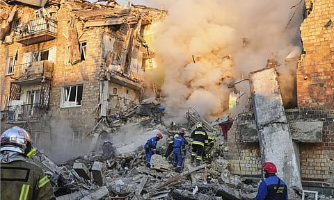 Firefighters work on the site of a burning building after a Russian attack in Kyiv, Ukraine (AP)