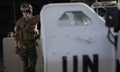 A French U.N. peacekeeper stands beside an armored vehicle at his base, waiting to move with his unit for a patrol along the Lebanese-Israeli border in Deir Kifa, southern Lebanon (AP Photo)