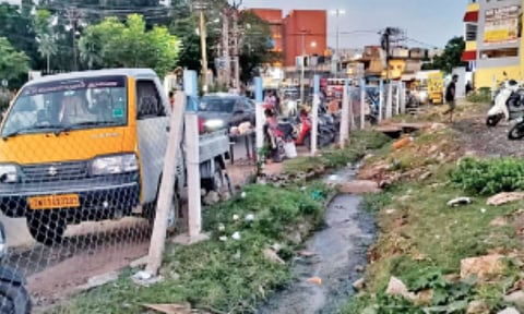 The open drain adjacent to Chitlapakkam 3rd Main Road obstructing entry and exit points of the two-wheeler parking area