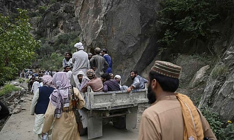 Residents from surrounding towns and villages try to reach the quake-hit region to assist survivors after Sunday night's powerful 6.0-magnitude earthquake that struck several provinces, in the Nurgol district, Kunar province, eastern Afghanistan (AP Photo)