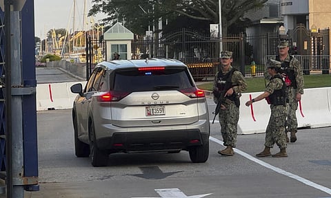 U.S. Navy Security Forces stand at the entrance to Gate 1 at the U.S. Naval Academy in Annapolis, Md (AP)