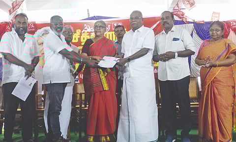 CPM polit bureau member K Balakrishnan handing over a will to donate his body at Yechury’s death anniversary event on Friday
