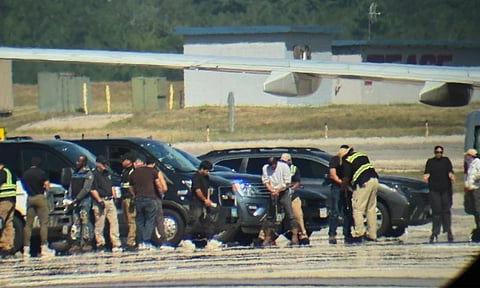 In this photo obtained by the Associated Press, ICE detainees line up to board a flight at Portsmouth International Airport at Pease (AP)
