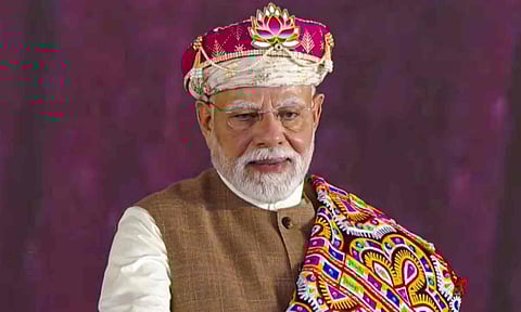 Prime Minister Narendra Modi being presented a memento by Madhya Pradesh Chief Minister Mohan Yadav, during the foundation stone laying ceremony of the PM Mitra Park, at Bhensola village in Badnawar tehsil of Dhar district, in Madhya Pradesh (PTI)&nbsp;