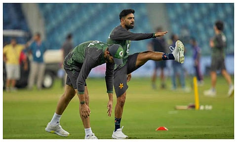 Pakistan's Haris Rauf and Shaheen Shah Afridi warm up before the start of the Asia Cup cricket match between Pakistan and United Arab Emirates at Dubai International Cricket Stadium, United Arab Emirates (PTI)&nbsp;