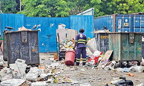A cleanliness worker handles waste without gloves at a collection point on Thanthai Periyar Nagar 1st Street&nbsp;