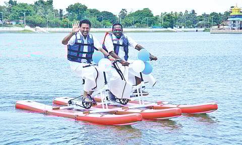 Minister Anbil Mahesh Poyyamozhi and Fisheries Development Corporation chair N Gowthaman riding a double water cycle