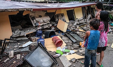 People look at a collapsed building in Bogo City, Cebu province, Philippines Wednesday, Oct. 1, 2025 after an offshore earthquake on late Tuesday.&nbsp;