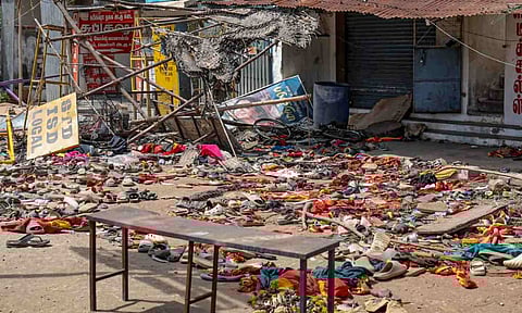 Footwear and other belongings of people lie on a road in the aftermath of stampede during a rally of actor and Tamilaga Vetri Kazhagam (TVK) chief Vijay, in Karur district, Tamil Nadu, Monday, Sept. 29, 2025 (PTI)&nbsp;