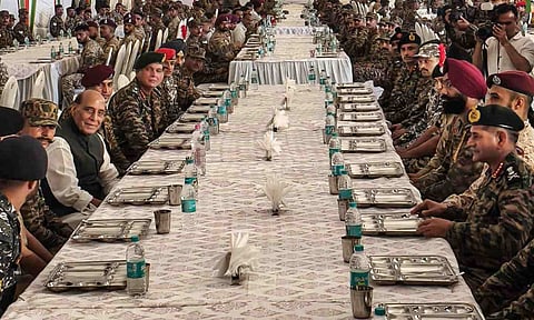 Union Defence Minister Rajnath Singh with soldiers during 'Barakhana', a feast, on the eve of the 'Dussehra' festival, in Bhuj, Kutch district, Gujarat (PTI)&nbsp;