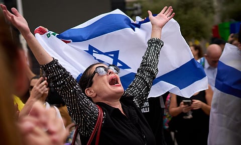 People react as they celebrate following the announcement that Israel and Hamas have agreed to the first phase of a peace plan (AP)&nbsp;