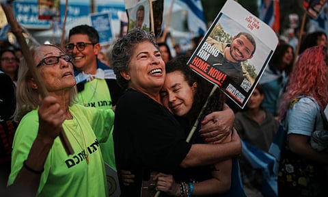 People gather prior to the release of Israeli hostages held in Gaza at a plaza known as the hostages square in Israel (AP)