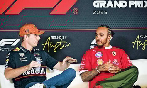 Max Verstappen (L) and Lewis Hamilton (R) speak during a press conference