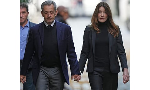 Former French President Nicolas Sarkozy, hand-in-hand with his wife Carla Bruni-Sarkozy, walked down his home’s alley Tuesday before heading to prison to serve time for a criminal conspiracy to finance his 2007 election campaign with funds from Libya, the first ex-leader of modern France to be imprisoned. His journey from the presidential Elysée Palace to the notorious La Santé prison in Paris has captivated France. (Photo: AP)