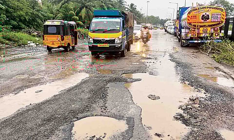 Potholes fill a portion of ever-busy Ennore High Road