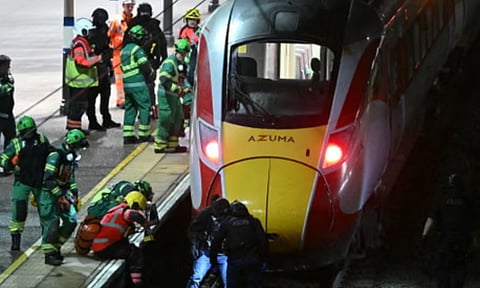 Police and emergency services search the track after the incident on a train to Huntingdon. (Credit: AFP)