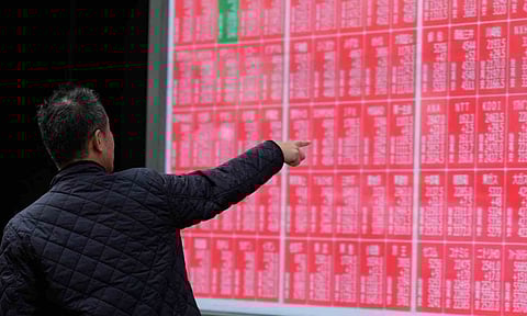 A person loots at an electronic stock board showing Japan's Nikkei index at a securities firm Monday, Oct. 27, 2025, in Tokyo (AP)&nbsp;