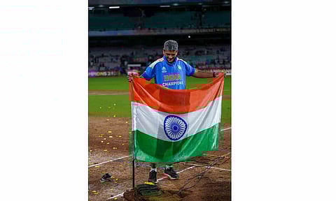 India's coach Amol Muzumdar plants the Indian tricolour on the pitch after the team won the ICC Women's World Cup 2025, at the DY Patil Stadium, in Navi Mumbai, early Monday, Nov. 3, 2025 (PTI)&nbsp;