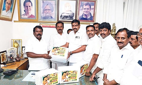 Madurai party head Karthekeyan handing over petitions with signatures against electoral malpractices to Selvaperunthagai