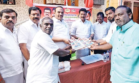 Anbil Mahesh Poyyamozhi handing over booklet to a Booth Level Agent in Tiruchy on Thursday