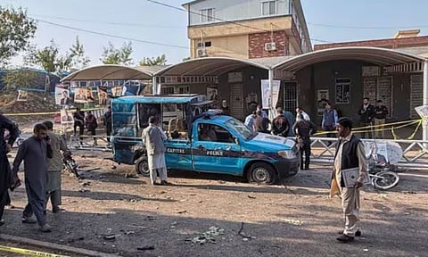 Security personnel inspect a damaged vehicle at the scene of a suicide bombing outside the district court gates in Islamabad, Pakistan, on Tuesday, November 11, 2025. (AP/PTI)