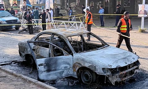 Security officials and rescue workers gather at the site following a suicide bombing outside the gates of a district court, in Islamabad, Pakistan (Photo: AP)