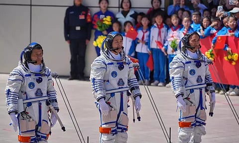 Chinese astronaut for the Shenzhou 20 mission, Chen Dong, center, speaks next to his comrades Chen Zhongrui, right, and Wang Jie as they attend a send-off ceremony for their manned space mission at the Jiuquan Satellite Launch Center in northwestern China (AP)