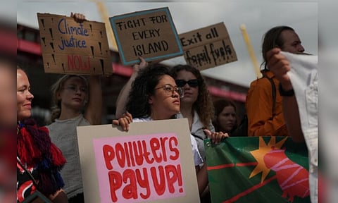 Rachelle Junsay, centre, stands with other activists participating in a youth climate demonstration during the COP30 U.N. Climate Summit, Friday, Nov. 14, 2025, in Belem, Brazil. (AP)