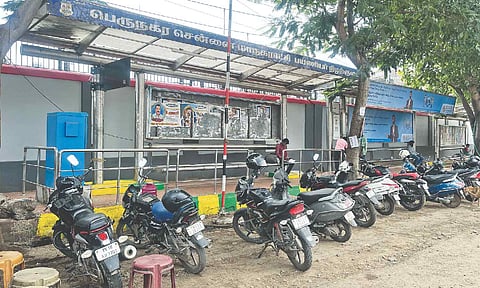Two-wheelers parked in front of the bus stop at Kallikuppam