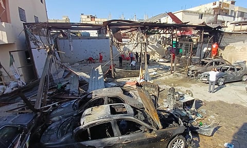 Palestinian rescue workers check the scene where an Israeli strike on Tuesday night hit the Ein el-Hilweh Palestinian refugee camp, in the southern port city of Sidon, Lebanon (AP)