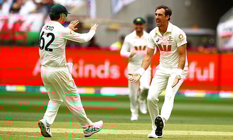 Australia’s Mitchell Starc, celebrates with teammate Travis Head the wicket of England’s Zak Crawley on day two in Perth. (Photo: AP)