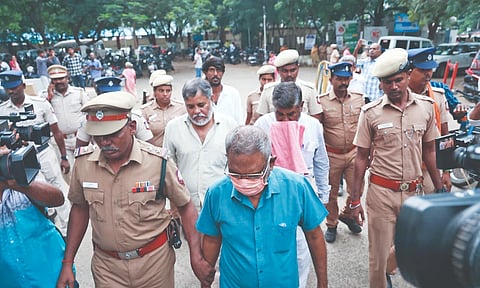 Rakesh, Jagadish and Ashok being escorted by police