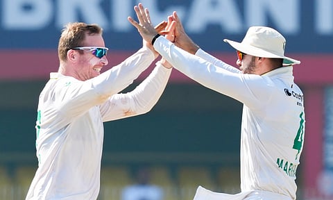 South Africa's Simon Harmer and Aiden Markram celebrate the wicket of India's captain Rishabh Pant during the fifth day of the second Test cricket match between India and South Africa, at ACA Stadium, Barsapara in Guwahati (PTI)