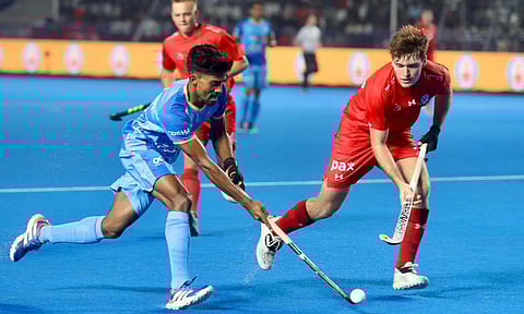 Rosan Kujur weaves past defenders to enter the shooting circle during the match