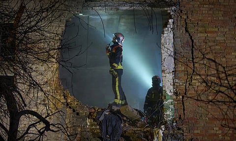 Rescuers search for victims after a drone hit a residential building during Russia's night missile and drone attack in Kyiv, Ukraine (AP)