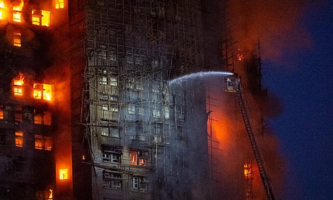 Firefighters tries to extinguish fire in the building (Photo: AP)